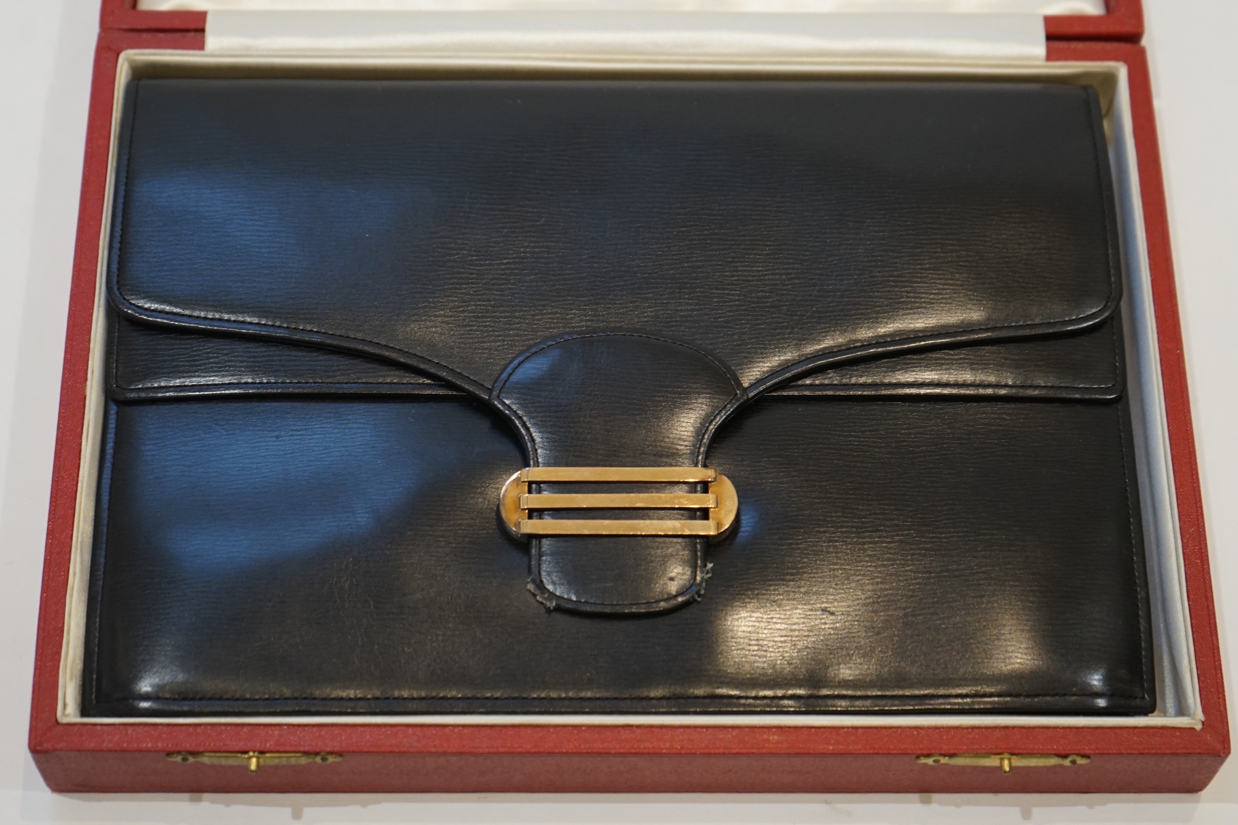 A vintage Cartier, London black leather handbag, fitted with original mirror and purse, in original box.